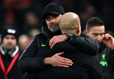 Liverpool manager Jurgen Klopp embraces Manchester City boss Pep Guardiola