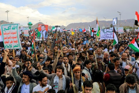 Yemenis brandish weapons as they march in the Huthi-run capital Sanaa in support of Palestinians and Hamas