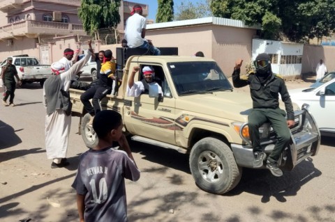 Fighters of a militia raised by Sudan's regular army patrol the streets of Gedaref