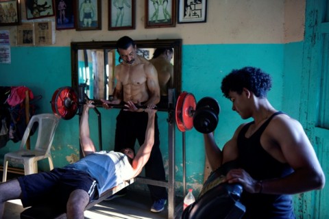 Walter Perez (C) helps a young man train in the gym he and his brother Arturo run in a town south of Managua