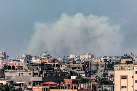 Smoke billows over Khan Yunis in the southern Gaza Strip during Israeli bombardment on March 17, 2024