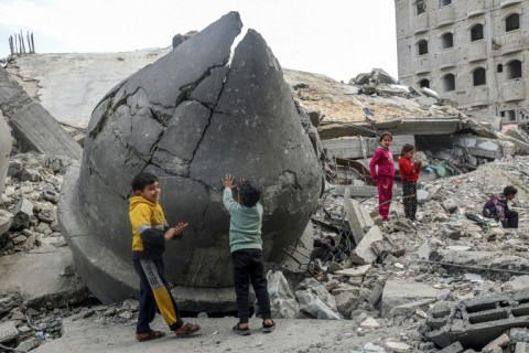 Children play in the rubble of the Al-Faruq Mosque, which was destroyed during Israeli bombardment, in Rafah in the southern Gaza Strip on March 17, 2024