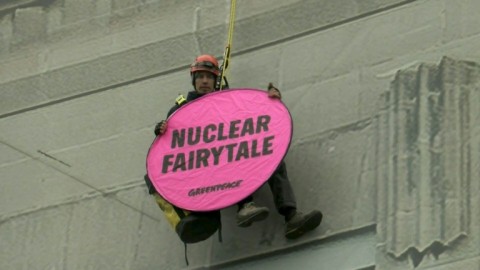 Greenpeace activist hangs from building hosting nuclear summit in Brussels