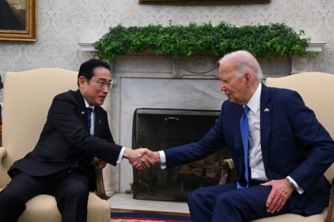 US President Joe Biden shakes hands with Japanese Prime Minister Fumio Kishida in the Oval Office of the White House in Washington, DC, on April 10, 2024.