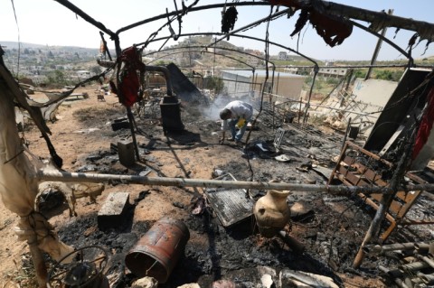 A burnt-out structure left in the aftermath of a raid by settlers