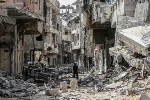 A Palestinian man walks through a destroyed neighbourhood in Khan Yunis in the southern Gaza Strip on April 22, 2024 amid the ongoing conflict 