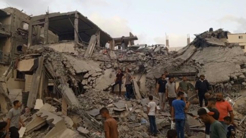 Gazans search through the rubble following Israeli strike on Deir El-Balah