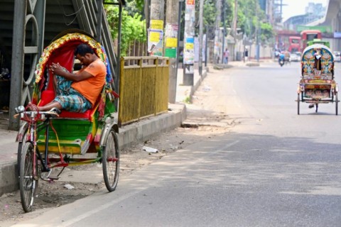 A rickshaw puller rests amid severe heatwave in the Bangladeshi capital Dhaka