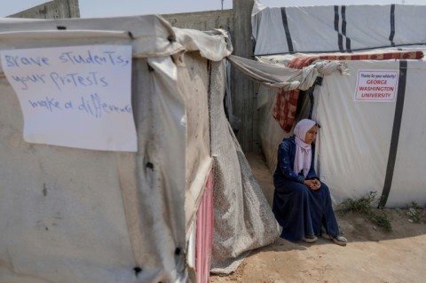 Relatives and supporters set up cardboard cutout portraits of Israeli women held hostage in Gaza outside Prime Minister Benjamin Netanyahu's Jerusalem residence 