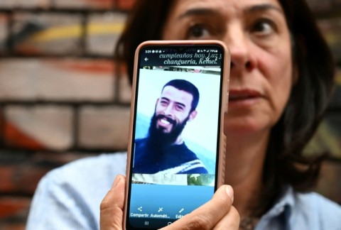 Margarita Arteaga shows a picture of her brother Kemel Mauricio Arteaga, who was killed by soldiers in 2007