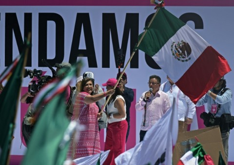 Opposition presidential candidate Xochitl Galvez waves the Mexican flag at a rally in the capital