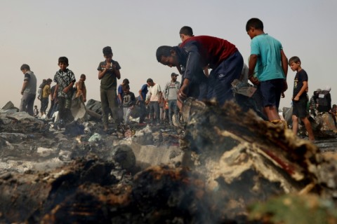 Palestinians gather at the site of an Israeli strike on a camp for internally displaced people in Rafah on May 27, 2024