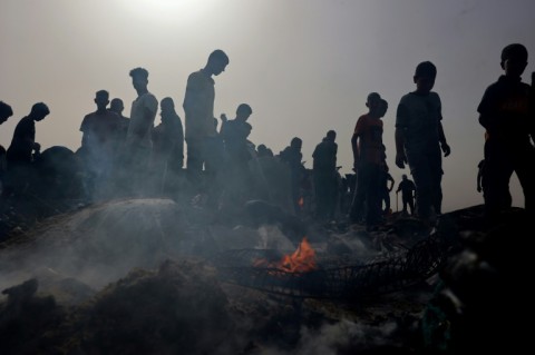 Palestinians gather at the site of an Israeli strike on a camp for internally displaced people in Rafah on May 27, 2024