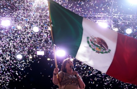 Opposition presidential candidate Xochitl Galvez waves the Mexican flag during a campaign rally