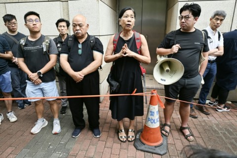 Veteran Hong Kong activist Chan Po-ying, wife of jailed pro-democracy campainger Leung Kwok-hung, speaks to the media outside the court before the verdict