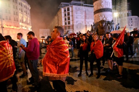 VMRO-DPMNE supporters wrapped in nationalist flags gather to celebrate their party's victory in North Macedonia's elections