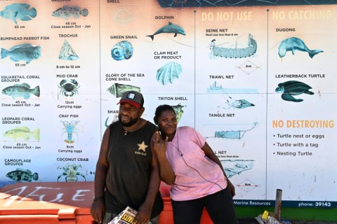 A faded sign at Honiara's seaside market warns against the live wildlife trade, singling out dolphins as a 'no sell' species