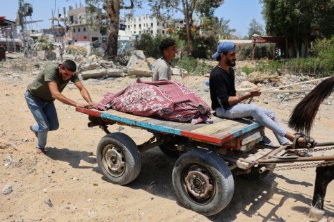 Palestinians evacuate bodies found in the rubble in the Tal Al-Hawa neighbourhood in Gaza City