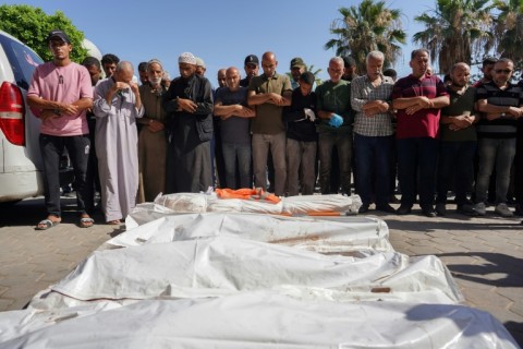 Palestinians mourn over the bodies of victims of Israeli bombardment, outside a hospital in Deir el-Balah on June 7, 2024