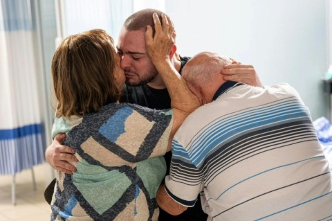 Israeli army handout picture showing Almog Meir Jan with his family after his release from Gaza captivity