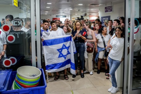 People gather at the central Israeli hospital where four hostages were taken after their rescue from Gaza captivity