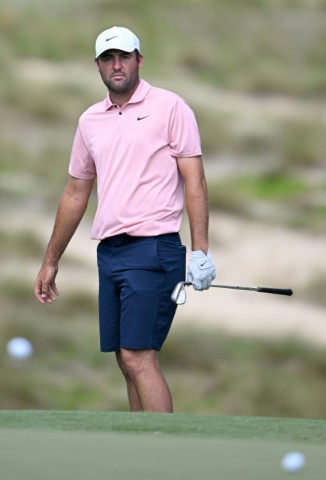 Top-ranked Scottie Scheffler of the United States chips to the fifth green during a practice round for the 124th US Open