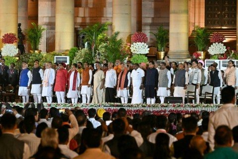 Indian Prime Minister Narendra Modi stands with his newly appointed 71-member Council of Ministers after their oath-taking ceremony on Sunday