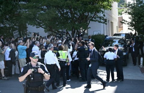 US Capitol police officers hold back media and protesters as former US president and Republican presidential candidate Donald Trump arrives for a meeting with US House Republicans on Capitol Hill in Washington, DC, on June 13, 2024