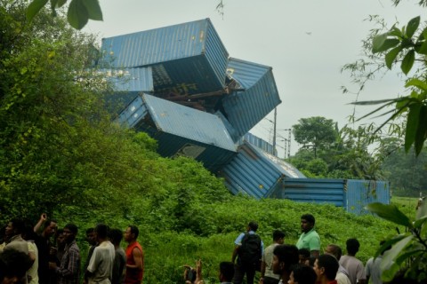 Carriages of the goods train were thrown off the rails in a tumbled pile after the collision on Monday in West Bengal state