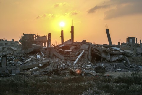 The sun rises over destroyed buildings in Khan Yunis, in the southern Gaza Strip