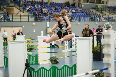 She's clear: A rider clears a fence during the Finnish Hobbyhorse Championships 