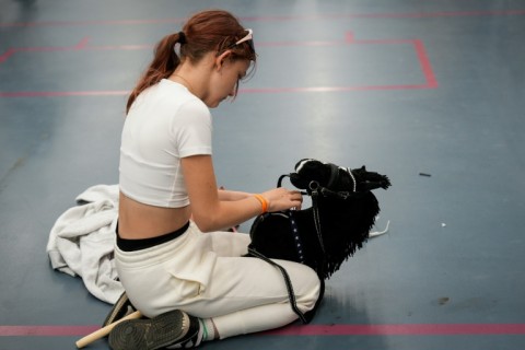 A girl prepares her steed at the Finnish hobbyhorse championships