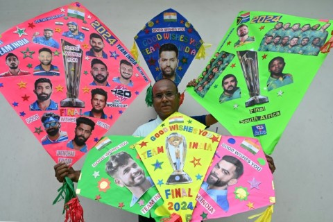 A man displays his kites decorated with pictures of Indian and South African cricket players in Amritsar, northern India