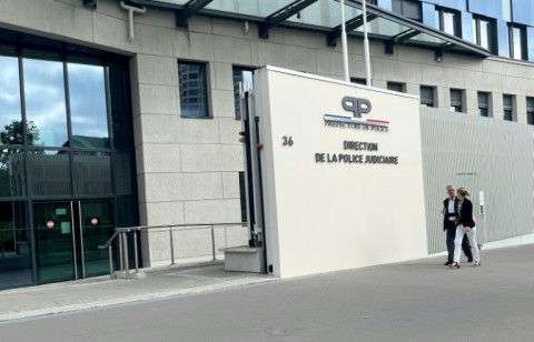 Jacquot (left) arrives at a Paris police station for questioning