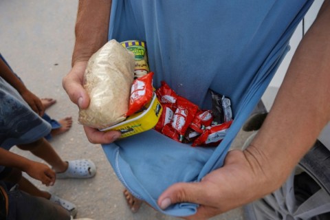 A Palestinian shows food collected from aid parcels airdropped in the Khan Yunis area, southern Gaza -- a UN-backed assessment said almost 500,000 people in Gaza are experiencing 'catastrophic' hunger