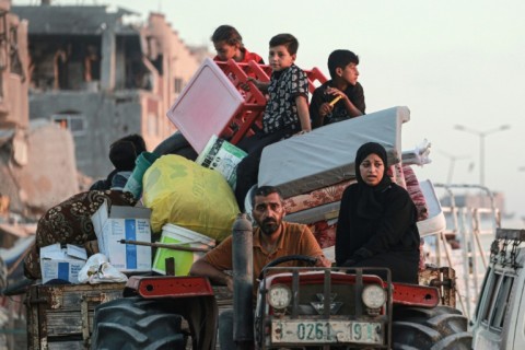 Displaced Palestinians leave an area of Khan Yunis after the Israeli army issued a new evacuation order, which the UN called the largest since the Israel-Hamas war began