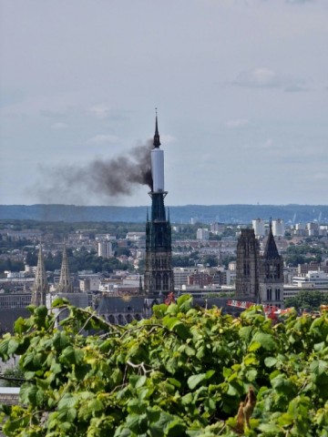 Smoke billows from the spire of Rouen Cathedral in Rouen, northern France on July 11, 2024