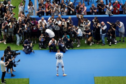 Kylian Mbappe poses for photos during his first appearance as a Real Madrid player at Santiago Bernabeu stadium 