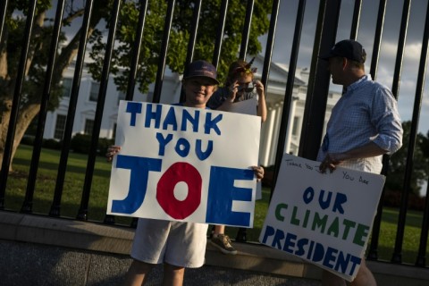 Biden's stunning move ignited an outpouring of praise for him as a patriot, with people outside the White House on Sunday holding up signs thanking him for his service