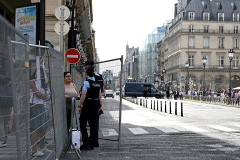 Tourists speak to police at security barriers as central Paris locks down for Friday's opening ceremony