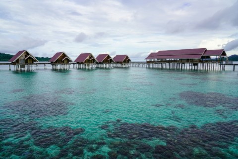 Government-built overwater bungalows for tourists, that have been closed for renovation, next to the village of the Bajau sea nomads in Pulau Papan in Sulawesi