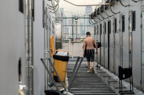 A former scam centre worker walking along detention rooms at a facility in Manila