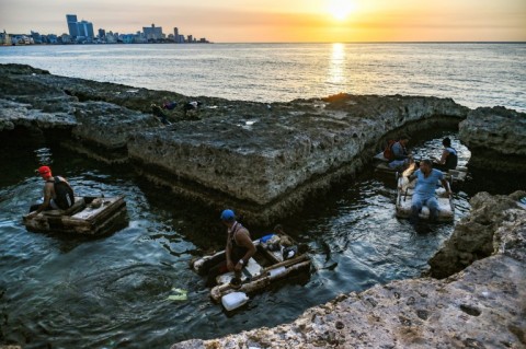 A group of Cuban fishermen sail out to sea to fish in their makeshift rafts 