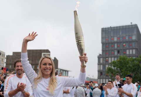 Former US skier Lindsey Vonn carries the Olympic torch