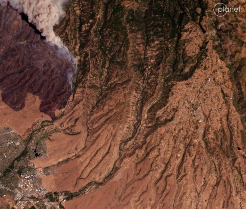 This aerial photo, taken above the town of Chico, California on July 25, 2024, shows smoke rising from the huge Park Fire