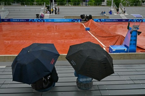 Rain pain: Spectators take shelter from the rain at Roland Garros 