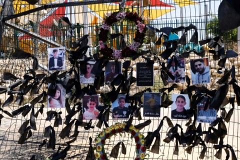 Portraits of the children and youngsters who were killed two days ago, hang on the football stadium fence where a rocket landed, in the Druze village of Majdal Shams in the Israeli-annexed Golan Heights