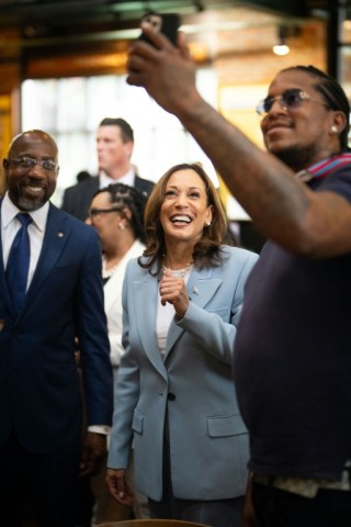 US Vice President Kamala Harris poses for a selfie as she visits Paschal's, a historic Black-owned restaurant, before holding a campaign rally in Atlanta, Georgia