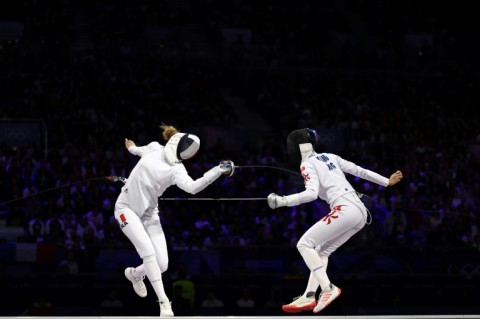 France's Auriane Mallo-Breton (left) and Hong Kong's Vivian Kong Man-wai joust in the  women's epee gold medal bout in Paris