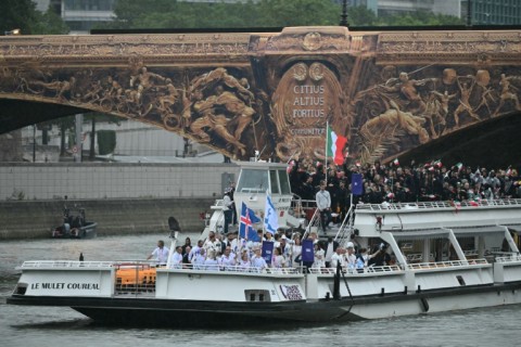 Chad's flag bearer Madaye Israel waves his country's flag (top right)at the Olympics opening ceremony in Paris